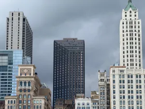 A captivating view of Chicago's skyline showcasing a mix of historic and modern architecture under ominous clouds. jigsaw puzzle
