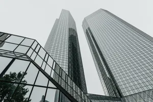 Low-angle view of modern skyscrapers with glass facades in an urban setting, showcasing contemporary architecture. jigsaw puzzle