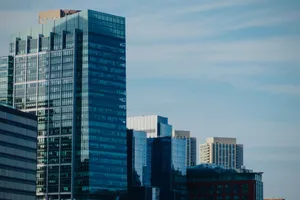 Stunning view of a modern urban skyline featuring glass skyscrapers under a clear blue sky. jigsaw puzzle