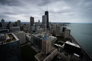 A dramatic aerial view of Chicago's skyline featuring iconic architecture and Lake Michigan. jigsaw puzzle