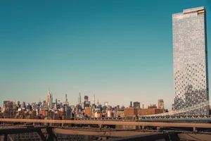 Panoramic view of New York City skyline and bridge under a clear sky. jigsaw puzzle