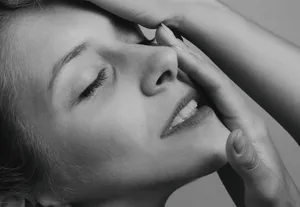 Close-up of a young woman's serene expression in monochrome. jigsaw puzzle