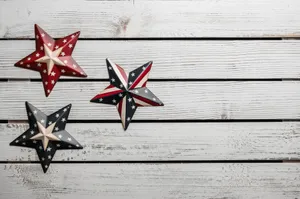 From above of various star shaped badges with pattern of United States flag placed on white wooden table jigsaw puzzle