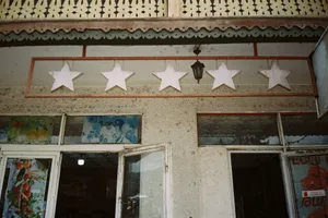 Low angle view of a vintage building facade featuring star decorations and intricate architectural details. jigsaw puzzle