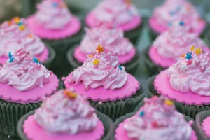 Close-up of freshly baked pink cupcakes with colorful sprinkles and frosting. jigsaw puzzle