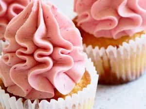 Delicious close-up image of pink-frosted cupcakes, perfect for dessert enthusiasts. jigsaw puzzle