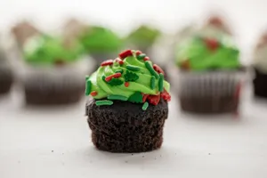 Chocolate cupcakes topped with festive green frosting and sprinkles. Perfect for holiday celebrations. jigsaw puzzle
