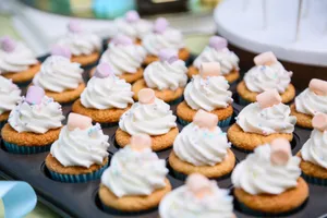 Close-up of cupcakes topped with whipped cream and marshmallows, perfect for dessert cravings. jigsaw puzzle