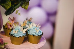 Beautifully decorated cupcakes with butterfly toppers and blue frosting, perfect for celebrations. jigsaw puzzle