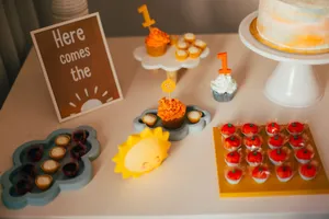 Charming first birthday party setup with cupcakes and sunny decorations. jigsaw puzzle