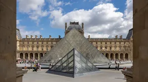 Explore the stunning glass pyramid at the Louvre Museum, Paris, on a sunny day. jigsaw puzzle