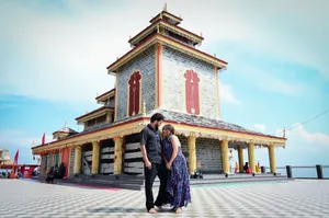 A loving couple embraces in front of a Hindu temple on a bright day in India, capturing cultural and romantic vibes. jigsaw puzzle