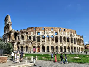 A stunning view of the Colosseum in Rome with tourists exploring the historic landmark. jigsaw puzzle