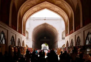 Vibrant scene of shoppers in a historic Indian arcade, capturing cultural architecture and lively market atmosphere. jigsaw puzzle