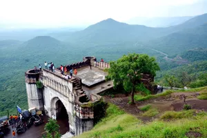Aerial view of fort with people overlooking lush green valley and hills. jigsaw puzzle
