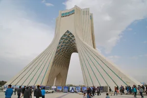 View of the iconic Azadi Tower in Tehran, Iran with visitors in the foreground on a clear day. jigsaw puzzle