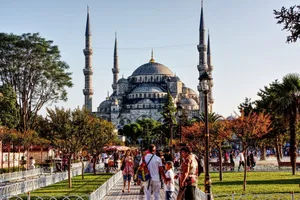 Sultan Ahmed Mosque and bustling tourists in Istanbul's vibrant Sultanahmet Park. jigsaw puzzle