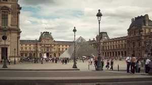 Crowds at the iconic Louvre Museum and its modern glass pyramid in Paris, France. jigsaw puzzle