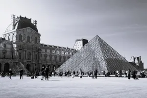 Black and white photograph of the iconic Louvre Pyramid in Paris, France. jigsaw puzzle