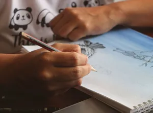 Hand sketching in a notebook with pencil, displaying artistic creativity. jigsaw puzzle