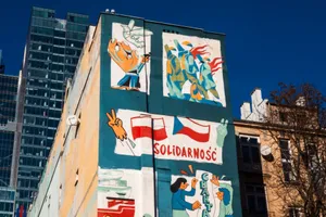 Vibrant street mural featuring flags and art on an urban building facade. jigsaw puzzle
