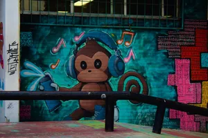 Vibrant street art of a monkey with headphones adorns a wall in Mexico City. jigsaw puzzle