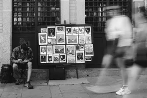 A street artist engaged in crafting art pieces on a busy street in Porto. jigsaw puzzle
