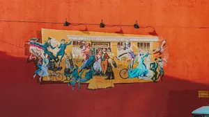 Street mural in Victoria, BC, depicting historical celebration and art on a red wall. jigsaw puzzle
