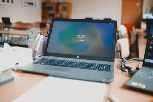 A classroom setting featuring laptops and desks, capturing a modern educational environment. jigsaw puzzle