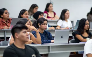 A diverse group of students attentively listens during a university lecture in Piura, Peru. jigsaw puzzle