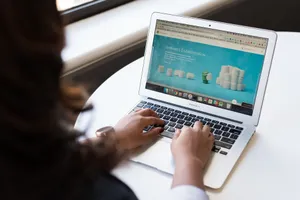 Businesswoman working on laptop with Android 6.0 Marshmallow webpage open. jigsaw puzzle