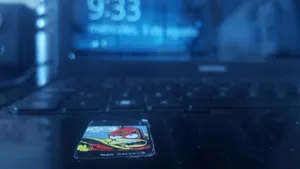 Bluescale close-up of a colorful sticker on keyboard with laptop screen in background. jigsaw puzzle