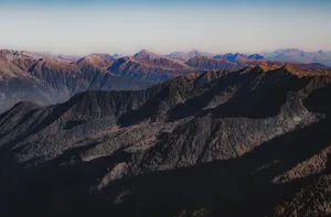 Panoramic view of sprawling mountains, casting long shadows at dawn. jigsaw puzzle