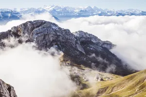 Breathtaking aerial shot of the Swiss Alps surrounded by clouds in Alpnach, Switzerland. jigsaw puzzle