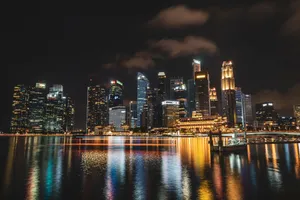 Dazzling night view of Singapore's illuminated skyline reflecting on water, showcasing modern skyscrapers. jigsaw puzzle