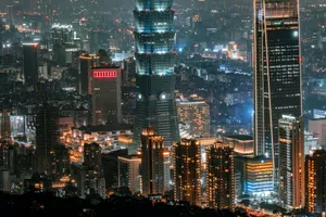 Illuminated Taipei cityscape featuring modern skyscrapers at night, showcasing urban architecture. jigsaw puzzle