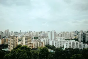 Aerial view of Singapore's urban skyline with modern architecture amidst greenery. jigsaw puzzle