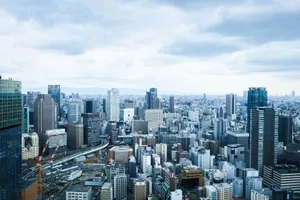A vibrant aerial view of Tokyo's modern skyline with skyscrapers under a cloudy sky. jigsaw puzzle