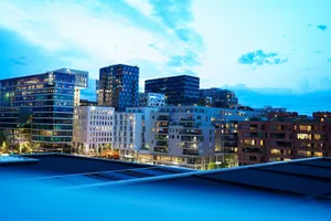 Illuminated modern buildings in Oslo's downtown at twilight, showcasing architecture. jigsaw puzzle