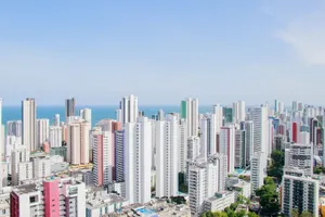 A panoramic view of Recife's skyline featuring modern skyscrapers and the Atlantic Ocean. jigsaw puzzle