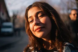 Close-up portrait of a young woman smiling warmly in the sun. jigsaw puzzle
