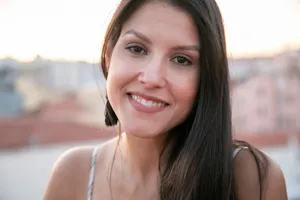 Outdoor portrait of a smiling woman in natural light, captured in Portugal during sunset. jigsaw puzzle