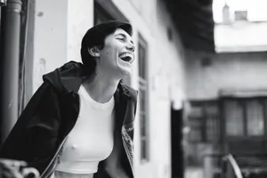 Black and white portrait of a joyful woman laughing in an urban setting in Lviv, Ukraine. jigsaw puzzle