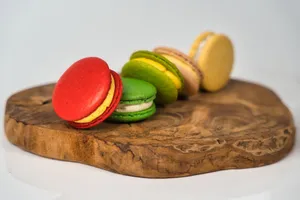 Vibrant French macarons displayed on a natural wooden platter, highlighting their rich colors and delicate texture. jigsaw puzzle