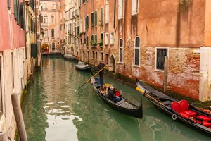Gondolas on a charming Venetian canal surrounded by historic architecture in Venice, Italy. jigsaw puzzle