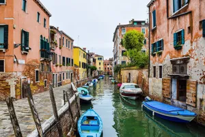 Picturesque view of a canal in Venice with moored boats and vibrant buildings. jigsaw puzzle