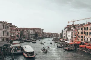 Boats on rippled water channel between old house facades under cloudy sky in harbor of Venice Italy jigsaw puzzle