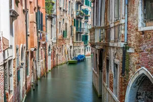 Picturesque scene of a Venetian canal between historic buildings, showcasing rustic architecture. jigsaw puzzle