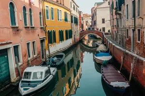 Picturesque view of a Venice canal with traditional boats and colorful buildings. jigsaw puzzle