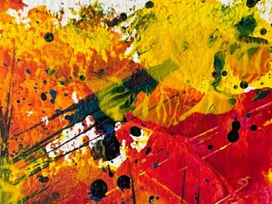 Dynamic abstract painting with vivid splashes of yellow, red, and blue, creating a modern artistic expression. jigsaw puzzle